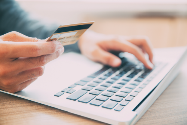 man with credit card processing payment online