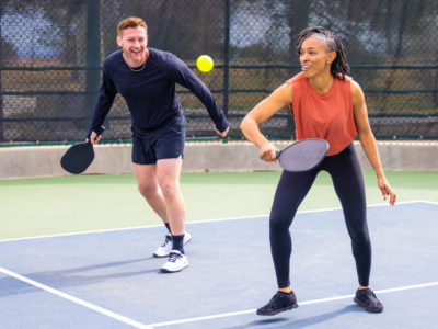 A man and a woman playing pickleball.